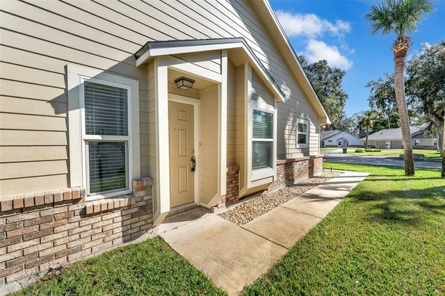 a view of a house with backyard and porch