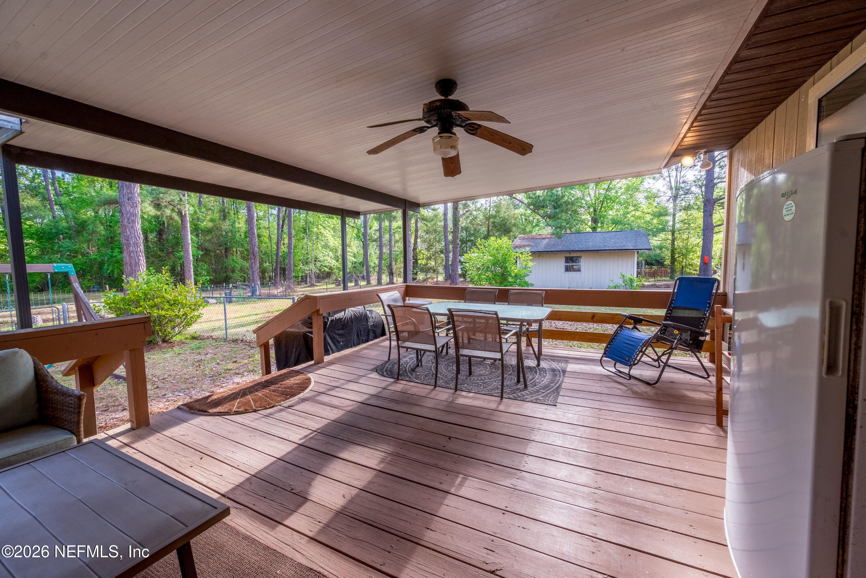 20021 Southeast 88th Trail Lake Butler, FL 32054 - Photo 12 of 43 a living room with patio furniture and a floor to ceiling window