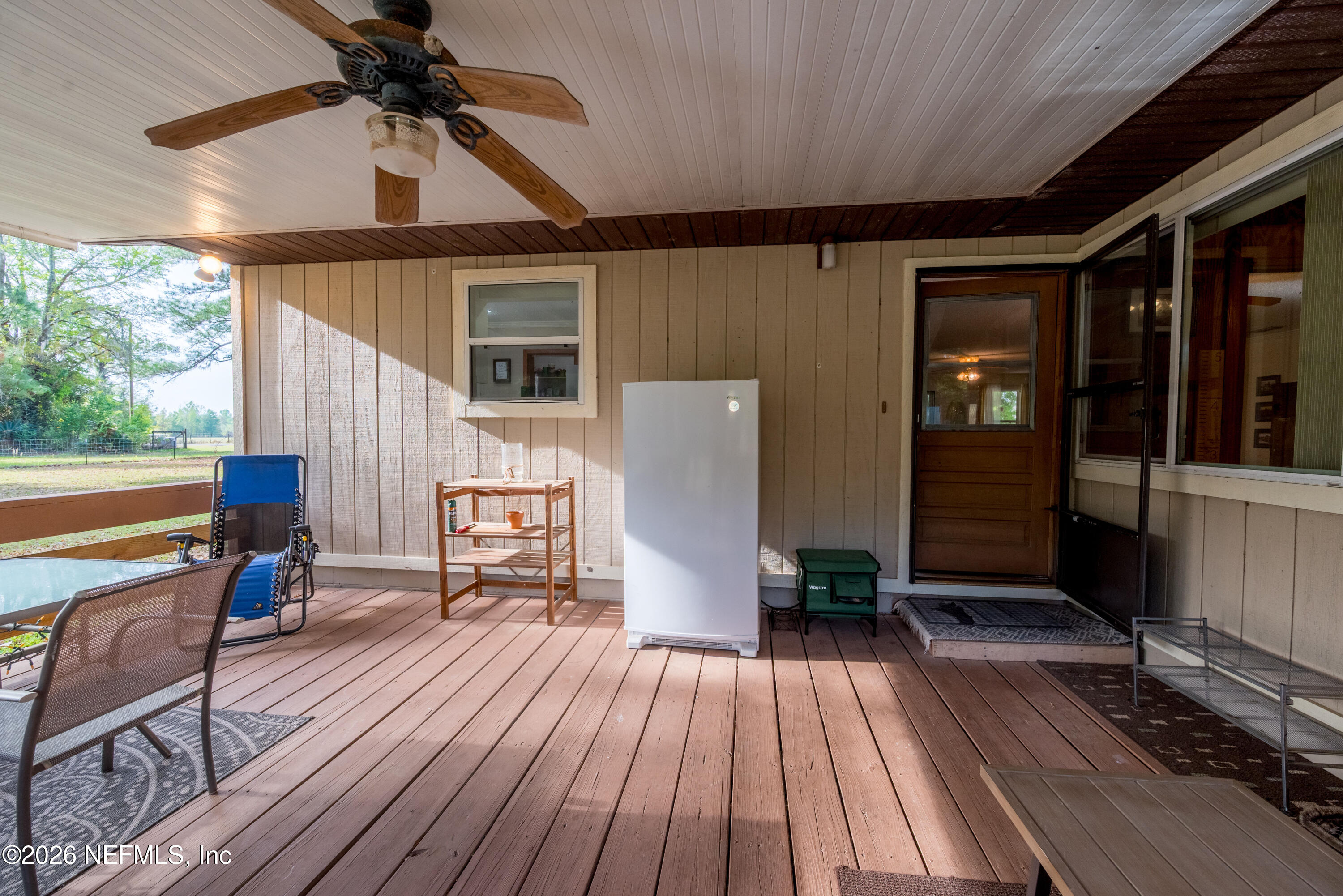 20021 Southeast 88th Trail Lake Butler, FL 32054 - Photo 14 of 43 a view of a patio with table and chairs and wooden floor