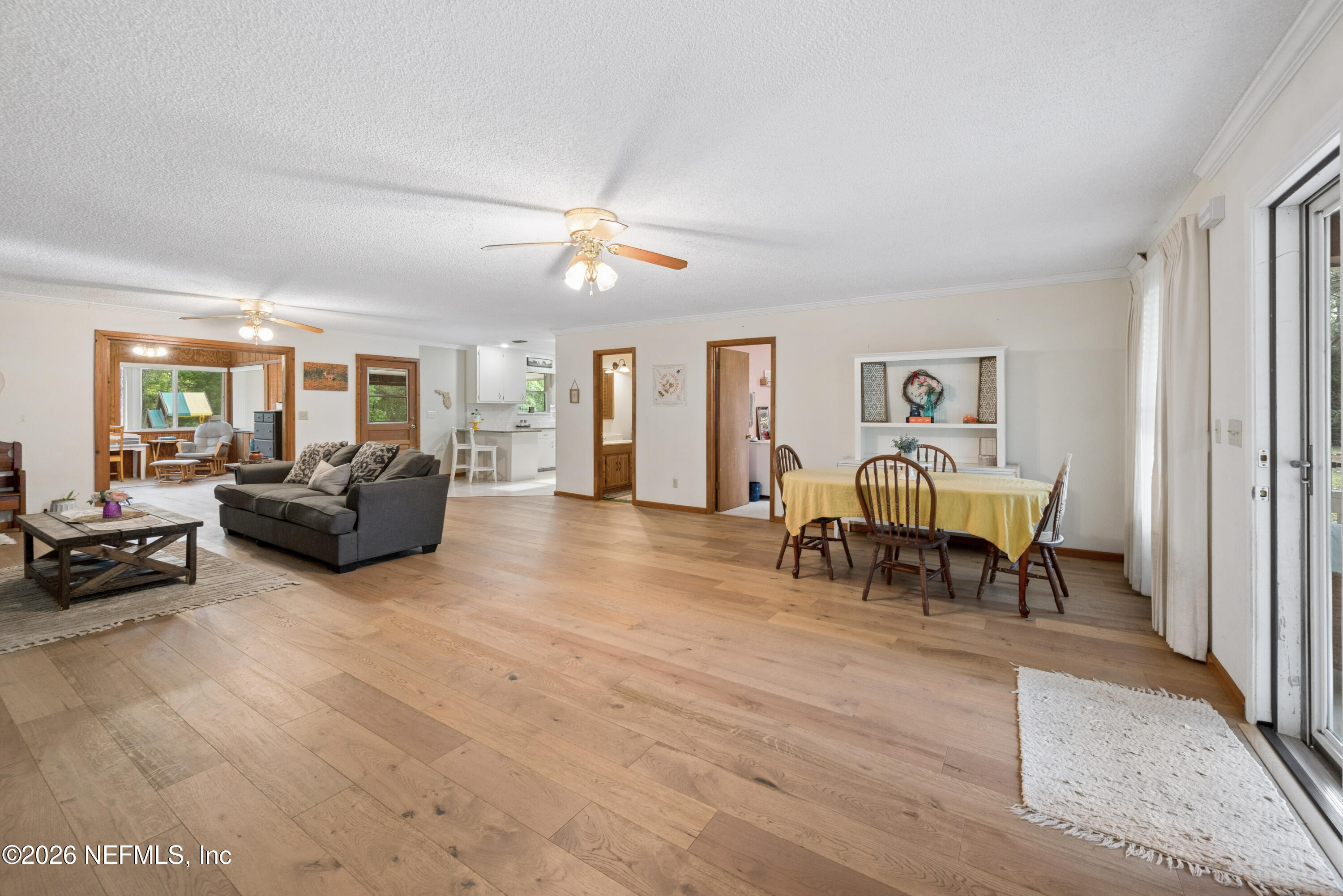 20021 Southeast 88th Trail Lake Butler, FL 32054 - Photo 16 of 43 a living room with furniture and a dining table with wooden floor