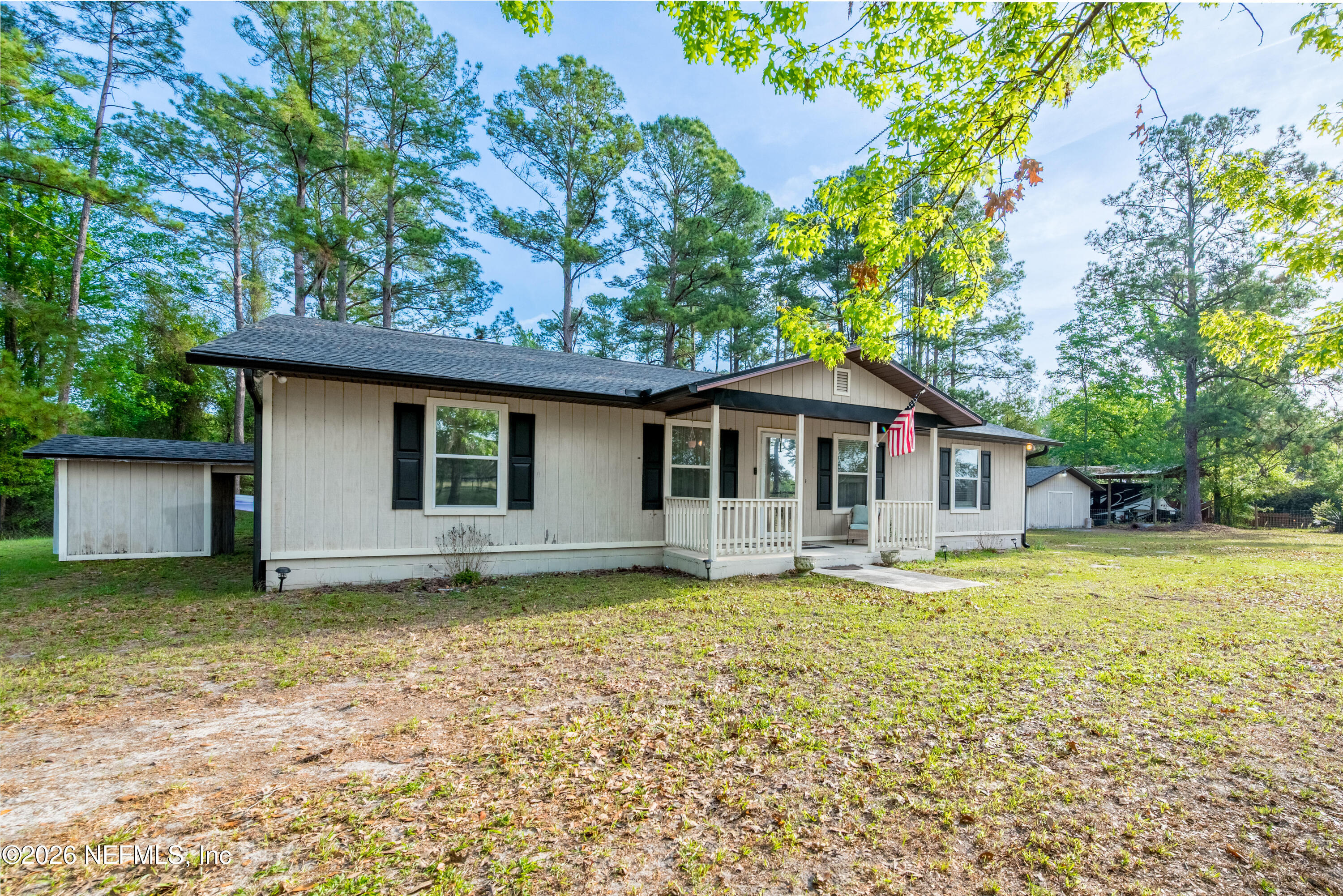 20021 Southeast 88th Trail Lake Butler, FL 32054 - Photo 2 of 43 a front view of a house with a garden and trees
