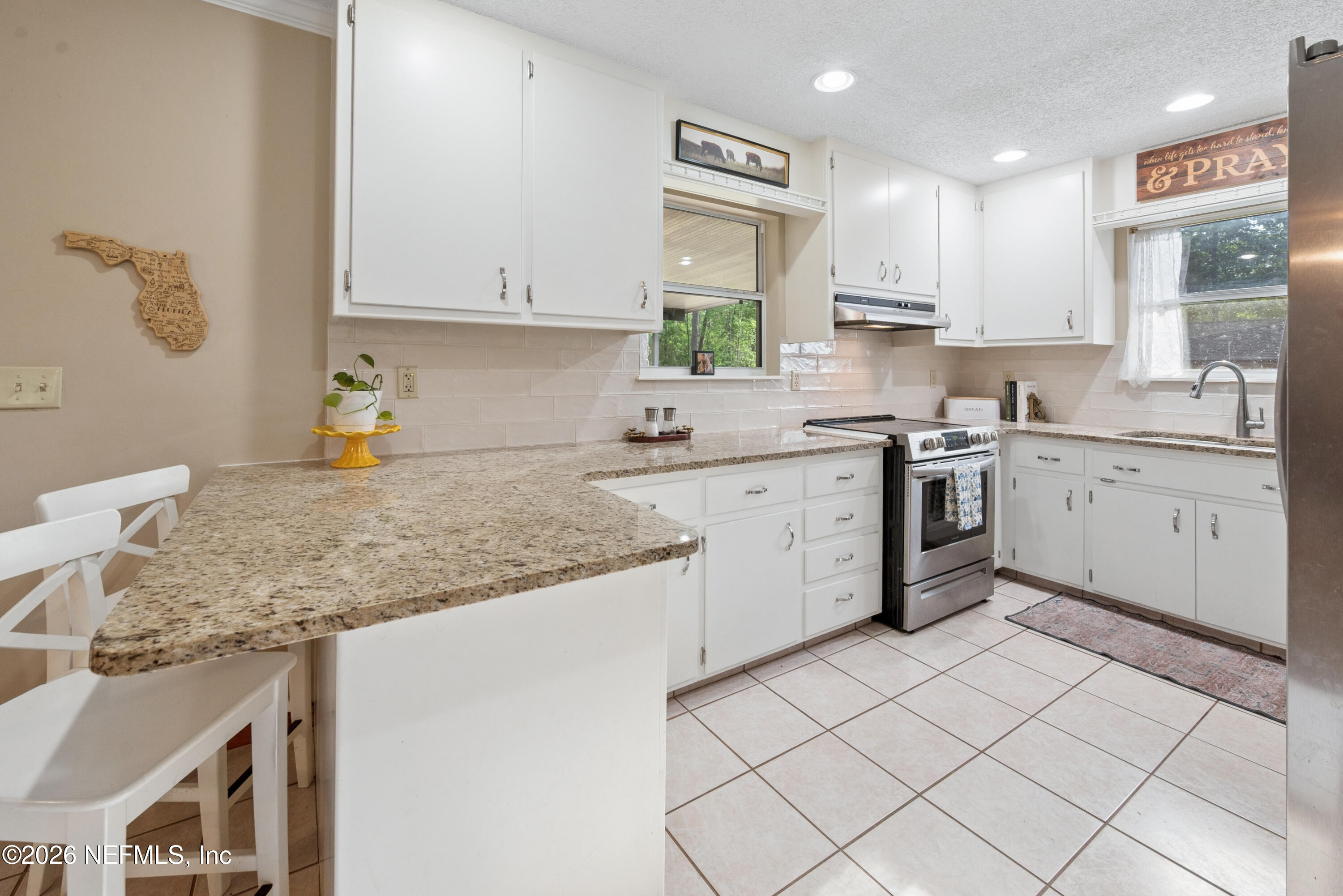 20021 Southeast 88th Trail Lake Butler, FL 32054 - Photo 25 of 43 a kitchen with a sink stove and cabinets