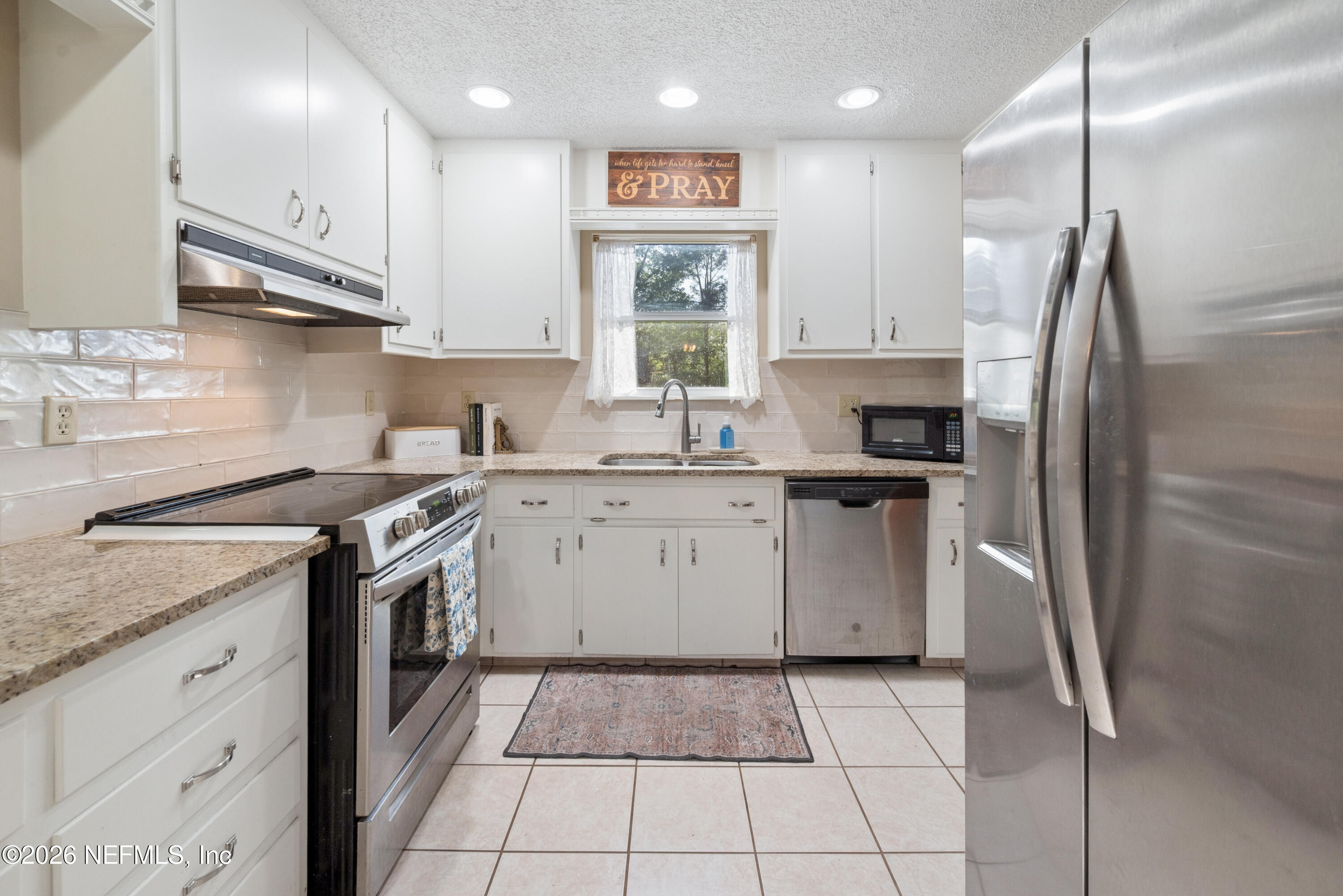 20021 Southeast 88th Trail Lake Butler, FL 32054 - Photo 26 of 43 a kitchen with stainless steel appliances granite countertop a sink a stove a refrigerator and a oven
