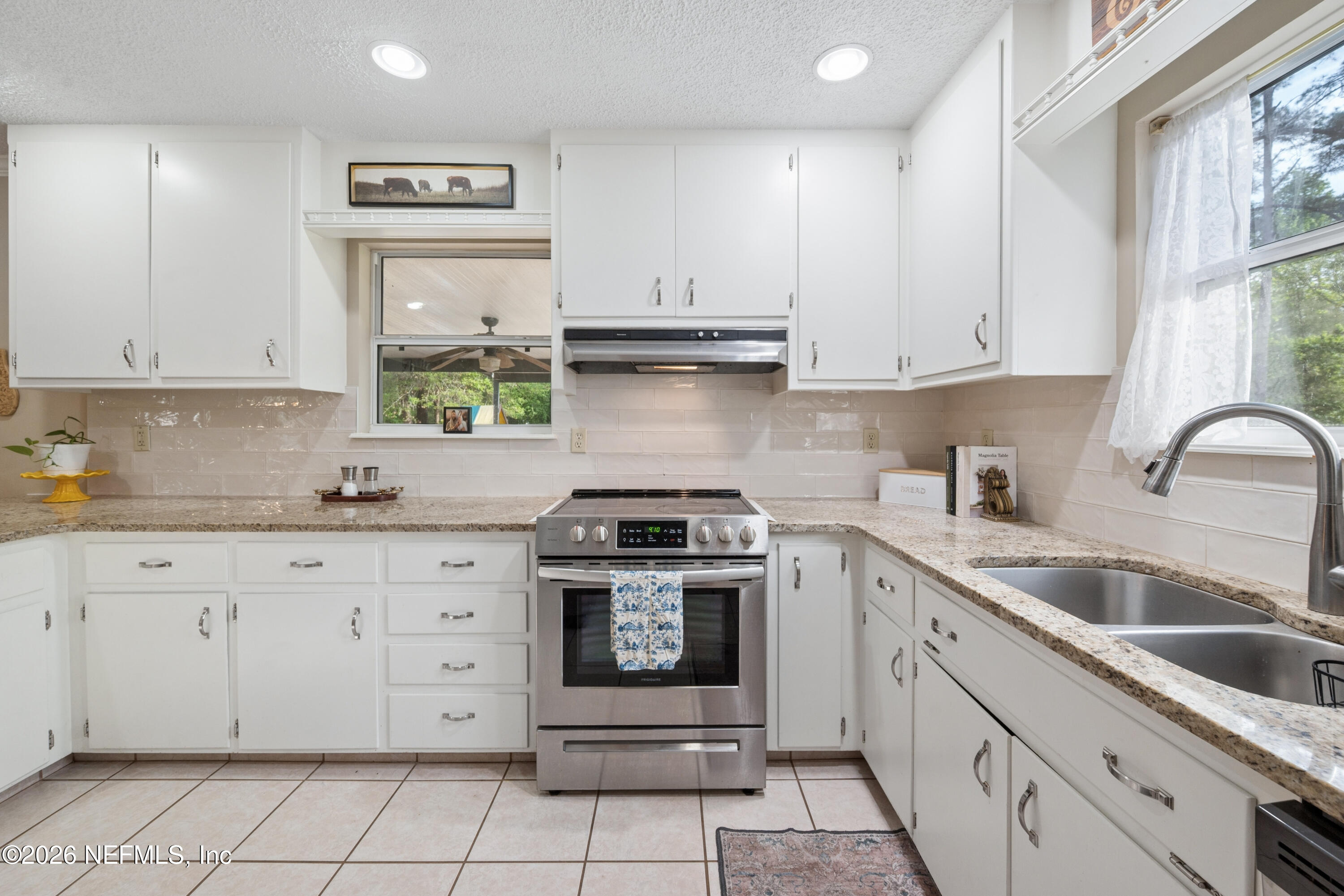 20021 Southeast 88th Trail Lake Butler, FL 32054 - Photo 27 of 43 a kitchen with granite countertop white cabinets and appliances