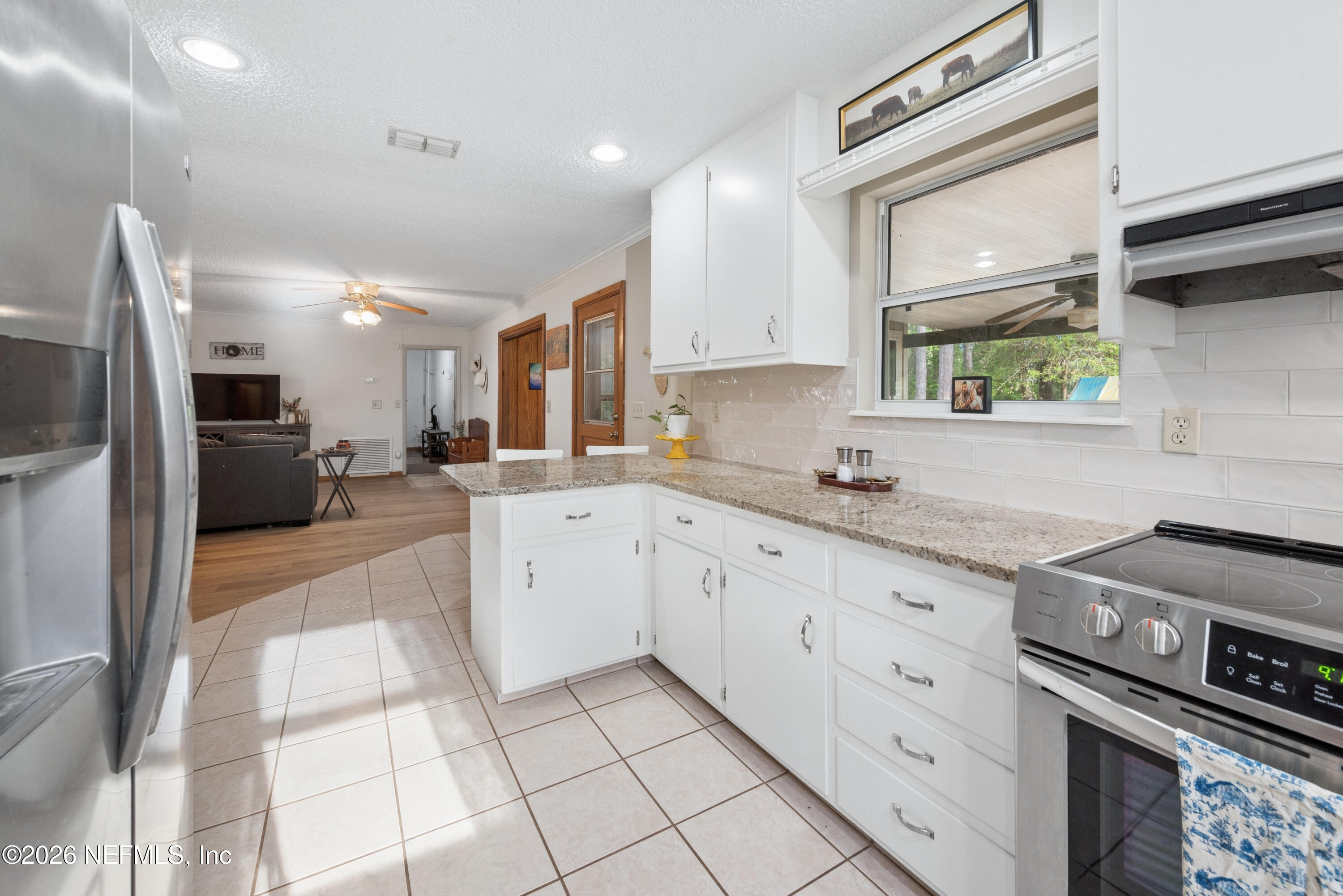 20021 Southeast 88th Trail Lake Butler, FL 32054 - Photo 28 of 43 a kitchen with stainless steel appliances kitchen island granite countertop a sink and cabinets
