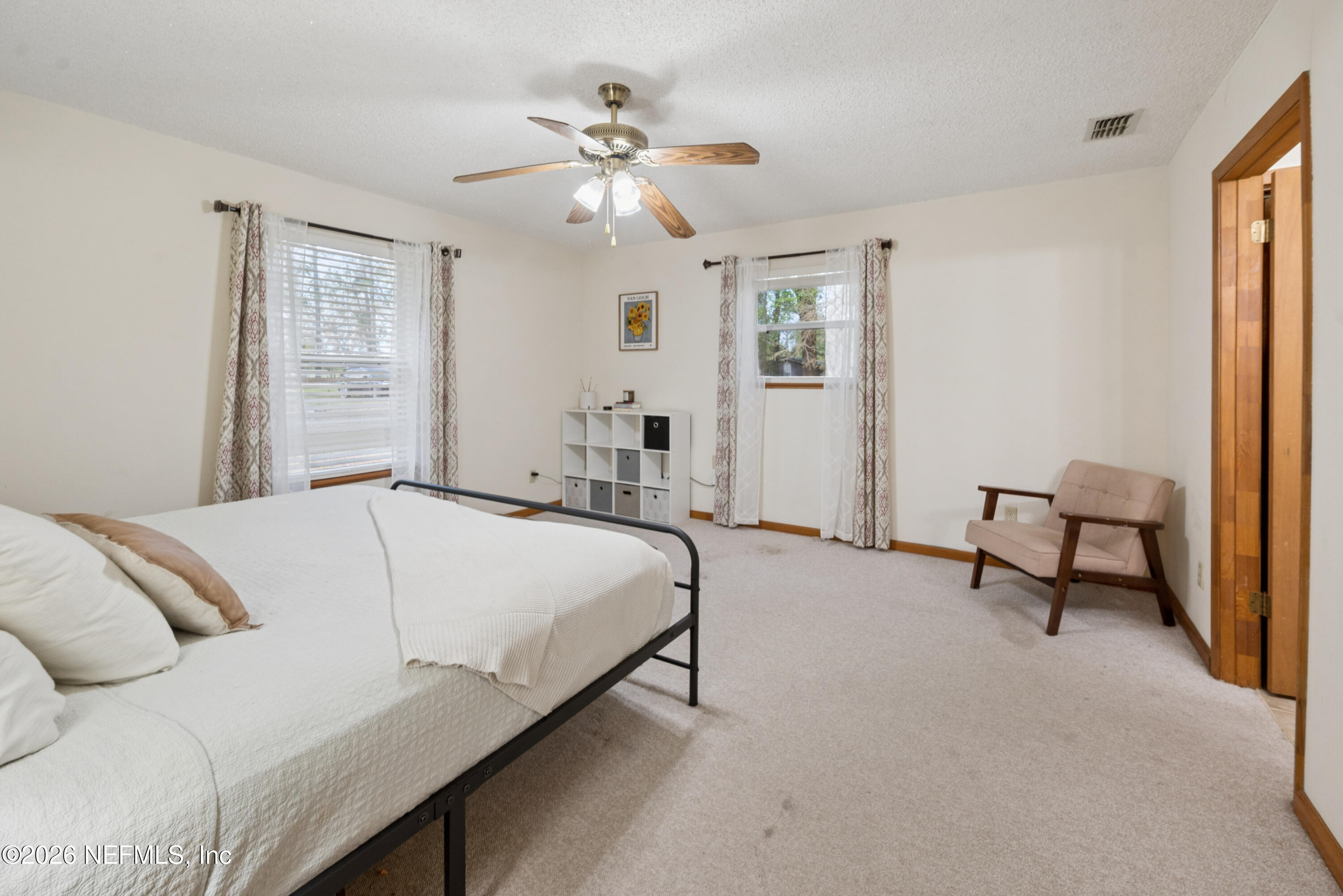 20021 Southeast 88th Trail Lake Butler, FL 32054 - Photo 32 of 43 a bedroom with a bed and a chandelier