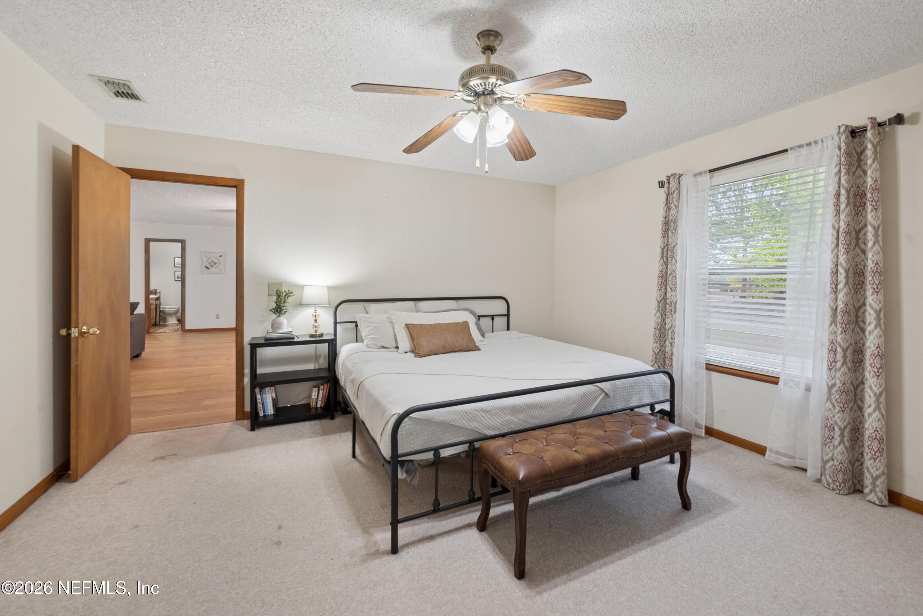 20021 Southeast 88th Trail Lake Butler, FL 32054 - Photo 33 of 43 a bedroom with a bed and a chandelier