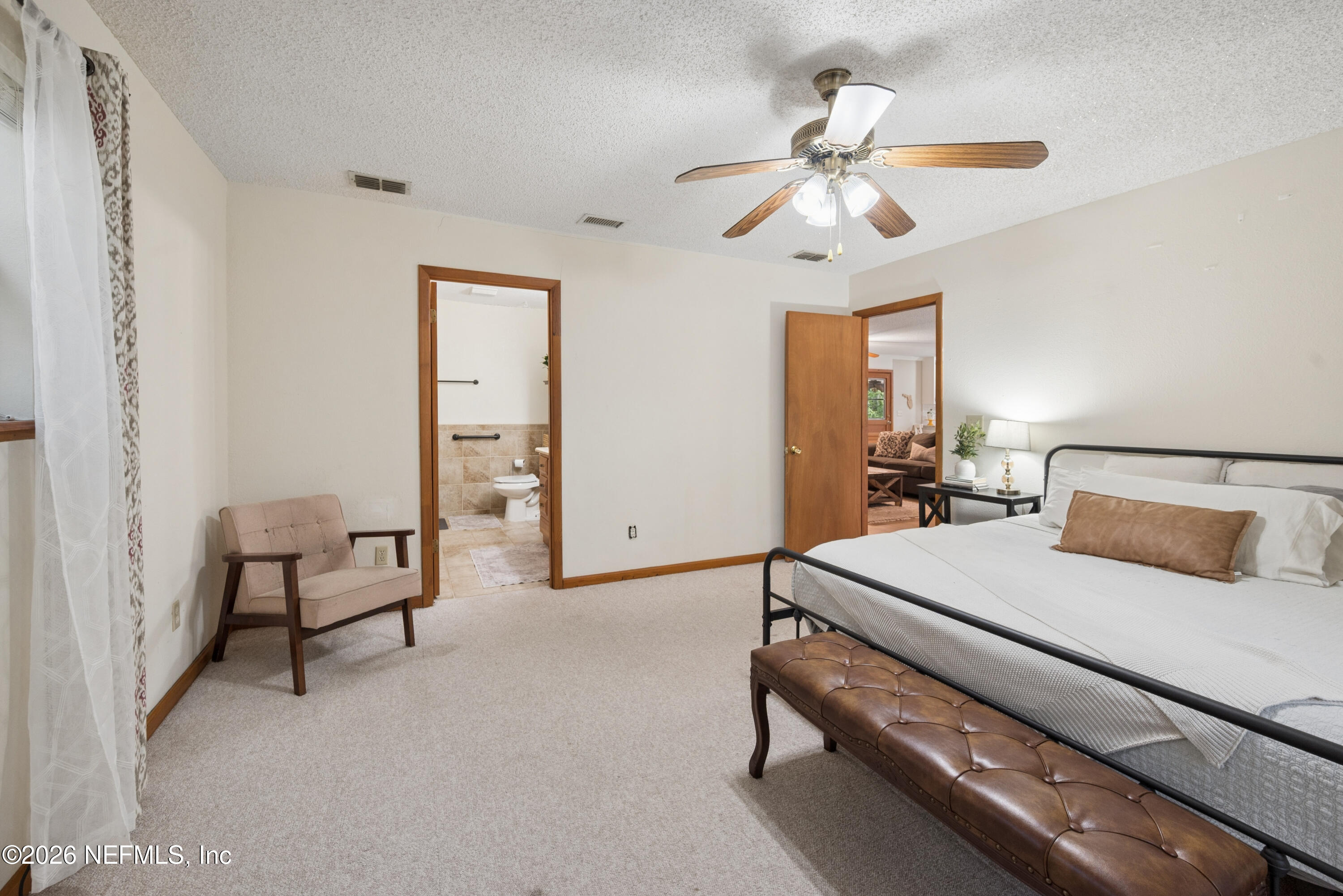 20021 Southeast 88th Trail Lake Butler, FL 32054 - Photo 34 of 43 a bedroom with a bed and a chandelier