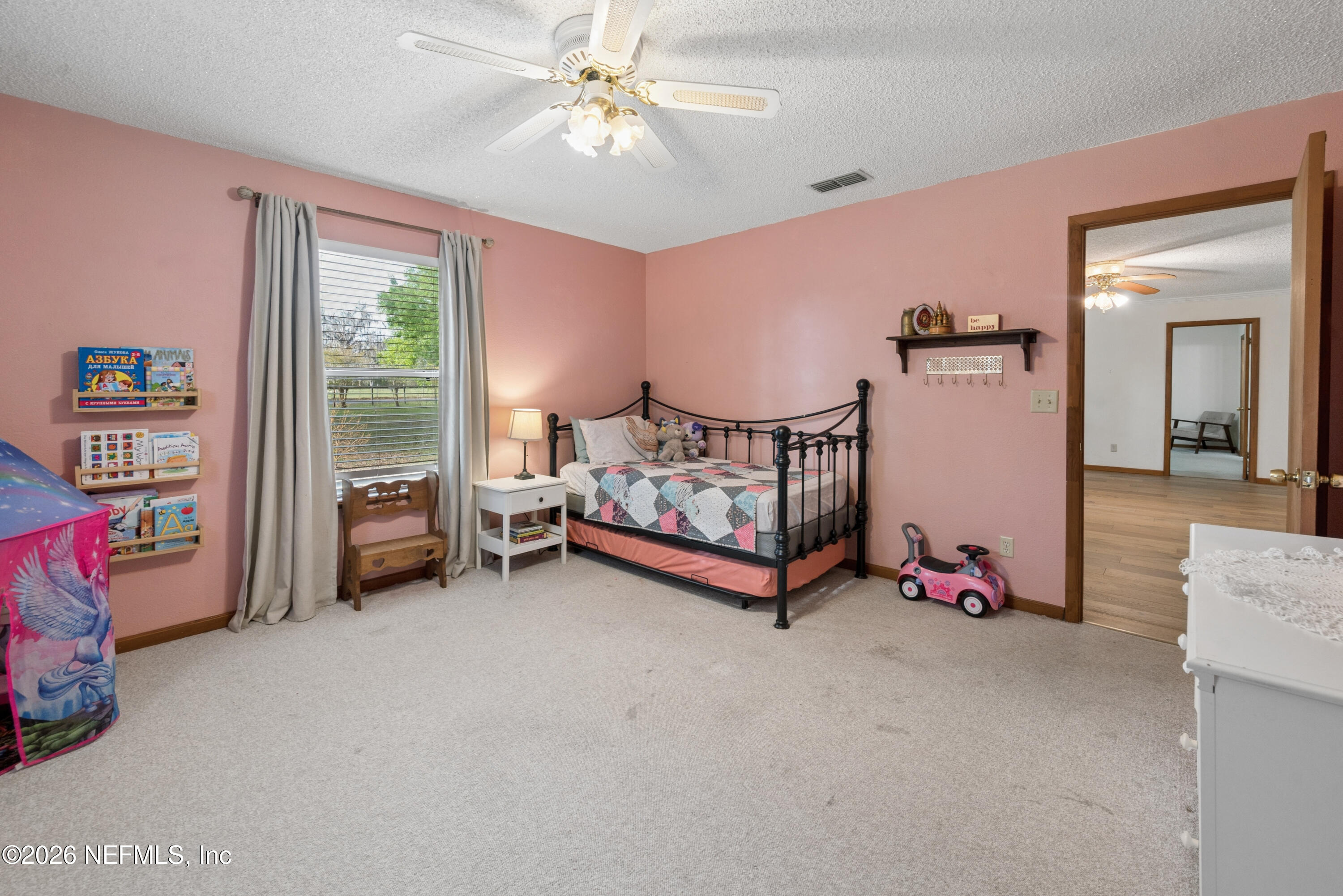 20021 Southeast 88th Trail Lake Butler, FL 32054 - Photo 38 of 43 a bedroom with furniture and a chandelier