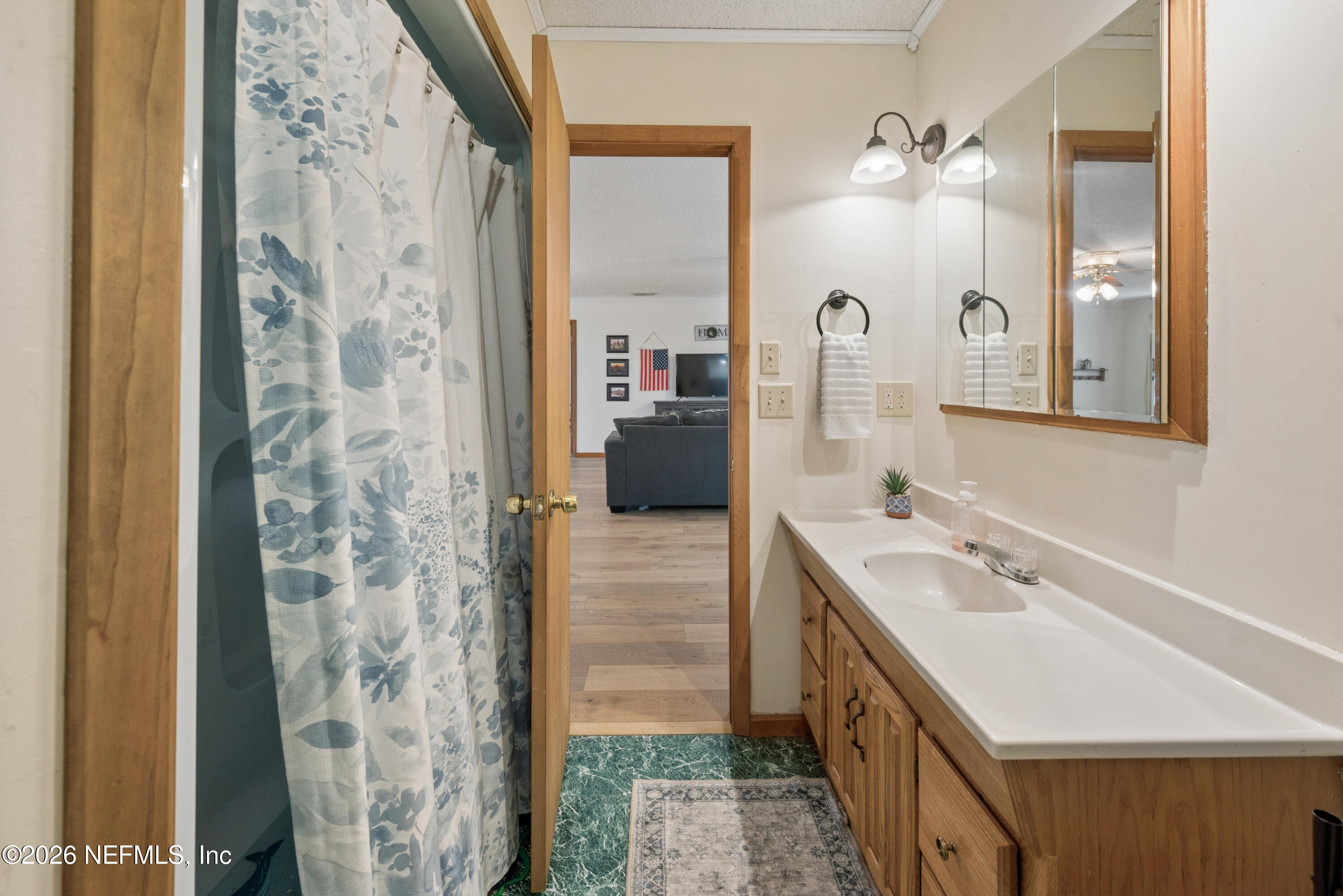 20021 Southeast 88th Trail Lake Butler, FL 32054 - Photo 39 of 43 a bathroom with a double vanity sink a toilet a mirror and shower
