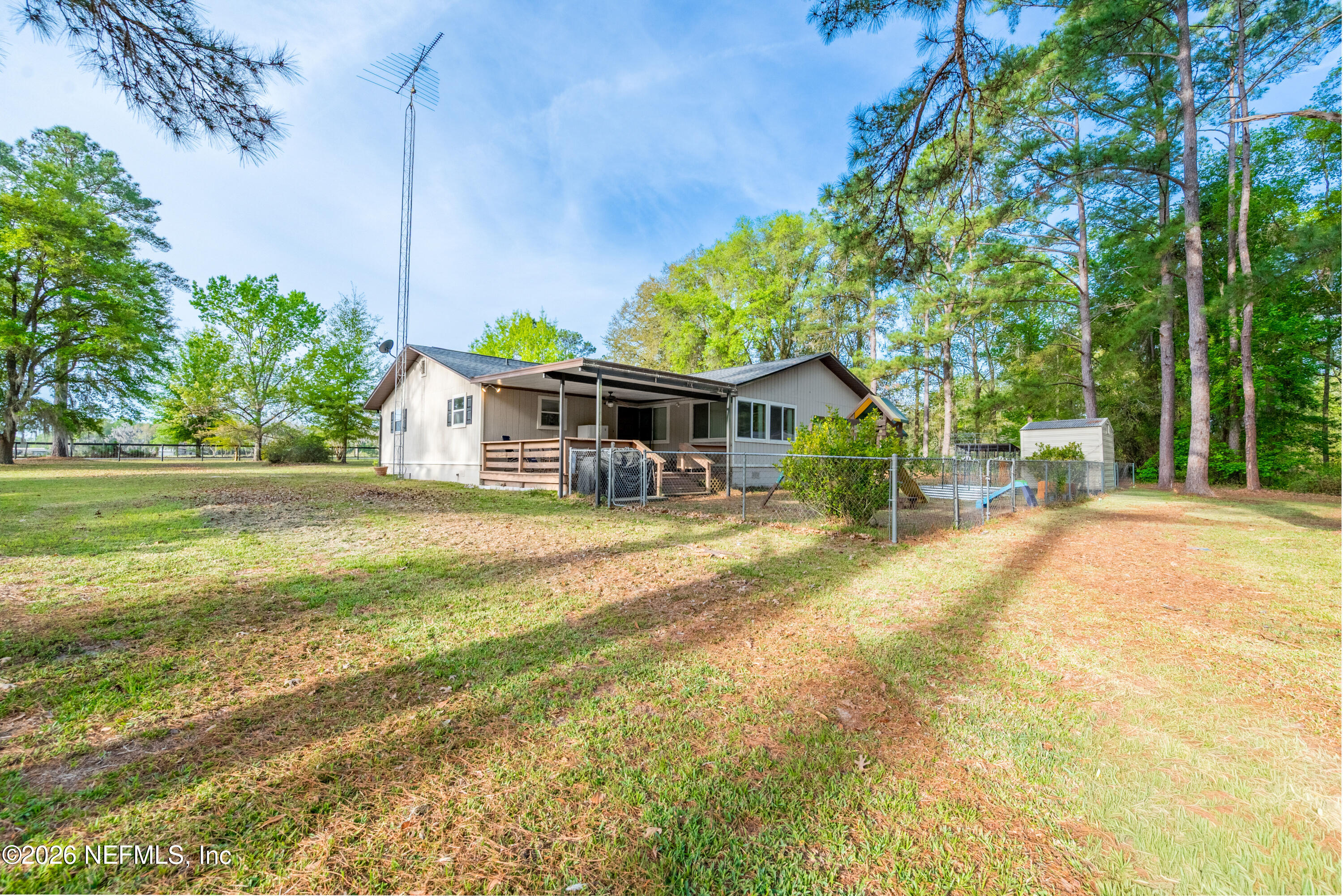 20021 Southeast 88th Trail Lake Butler, FL 32054 - Photo 5 of 43 a front view of a house with a yard table and chairs