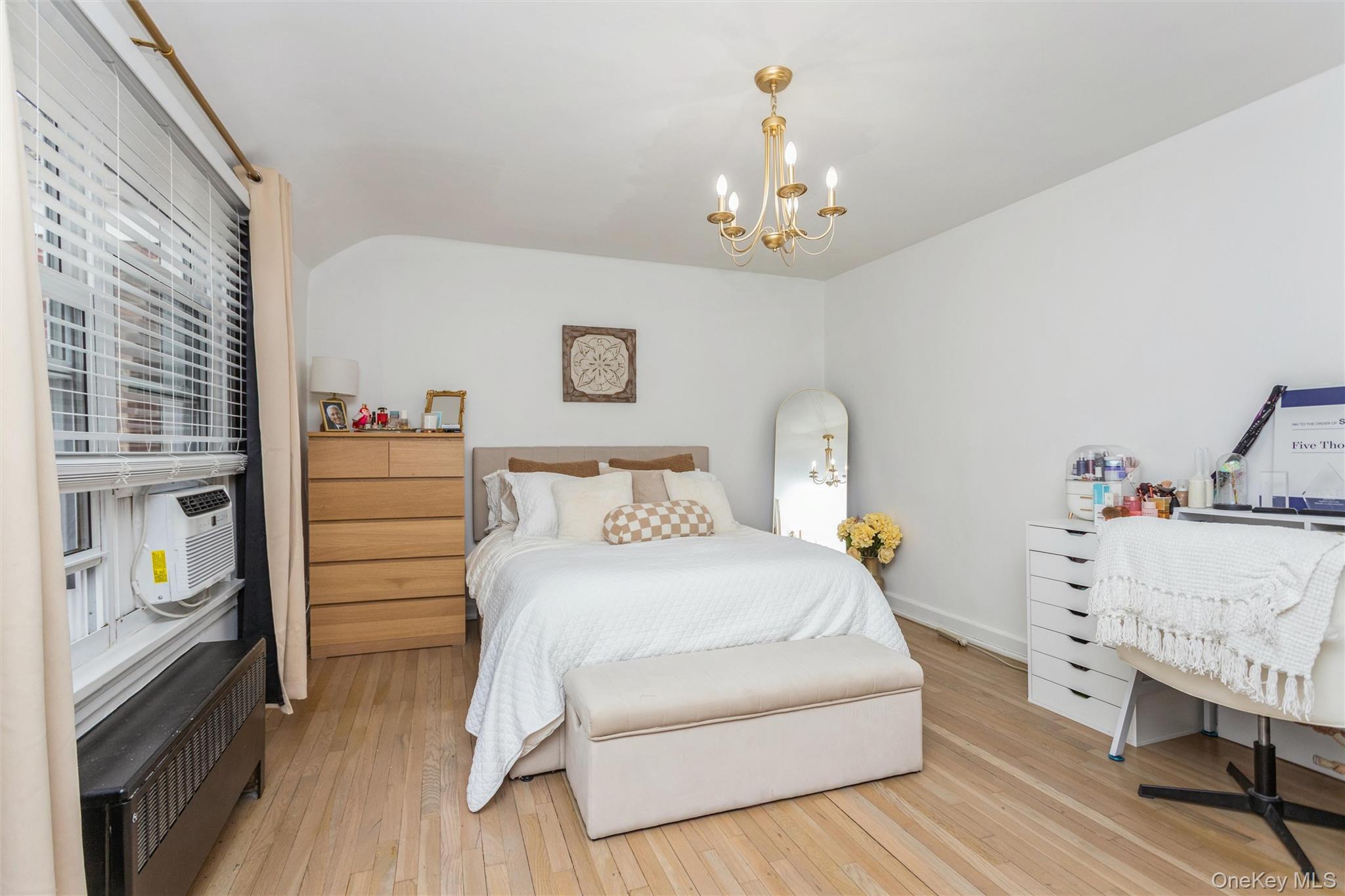 5 Peck Avenue, Unit 51B Rye, NY 10580 - Photo 20 of 31 a bedroom with a bed and a chandelier