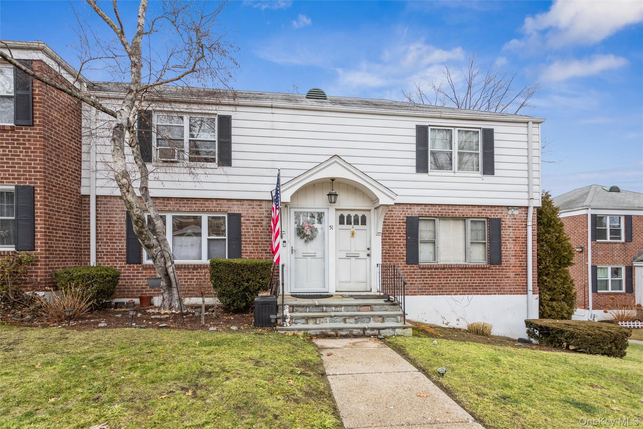5 Peck Avenue, Unit 51B Rye, NY 10580 - Photo 2 of 31 a front view of a house with a yard