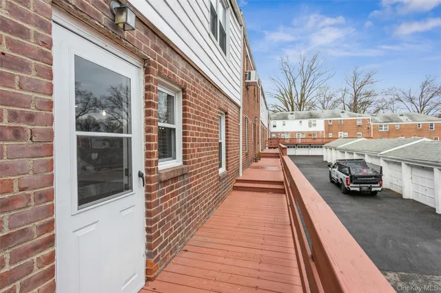 a view of a brick house with a large window