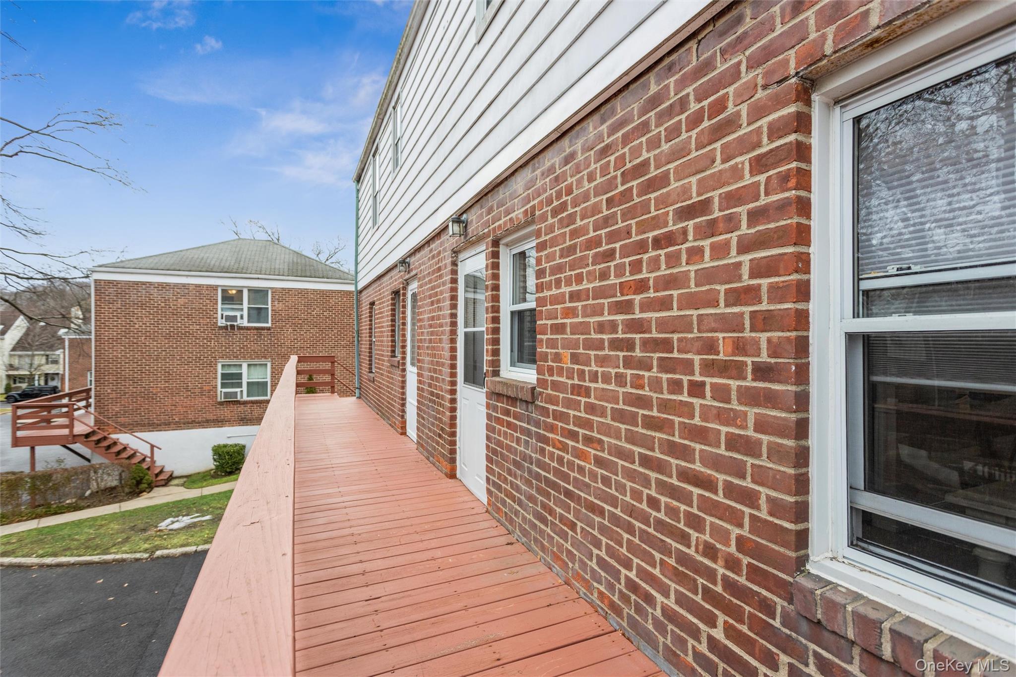 5 Peck Avenue, Unit 51B Rye, NY 10580 - Photo 24 of 31 a view of a brick house with a large window