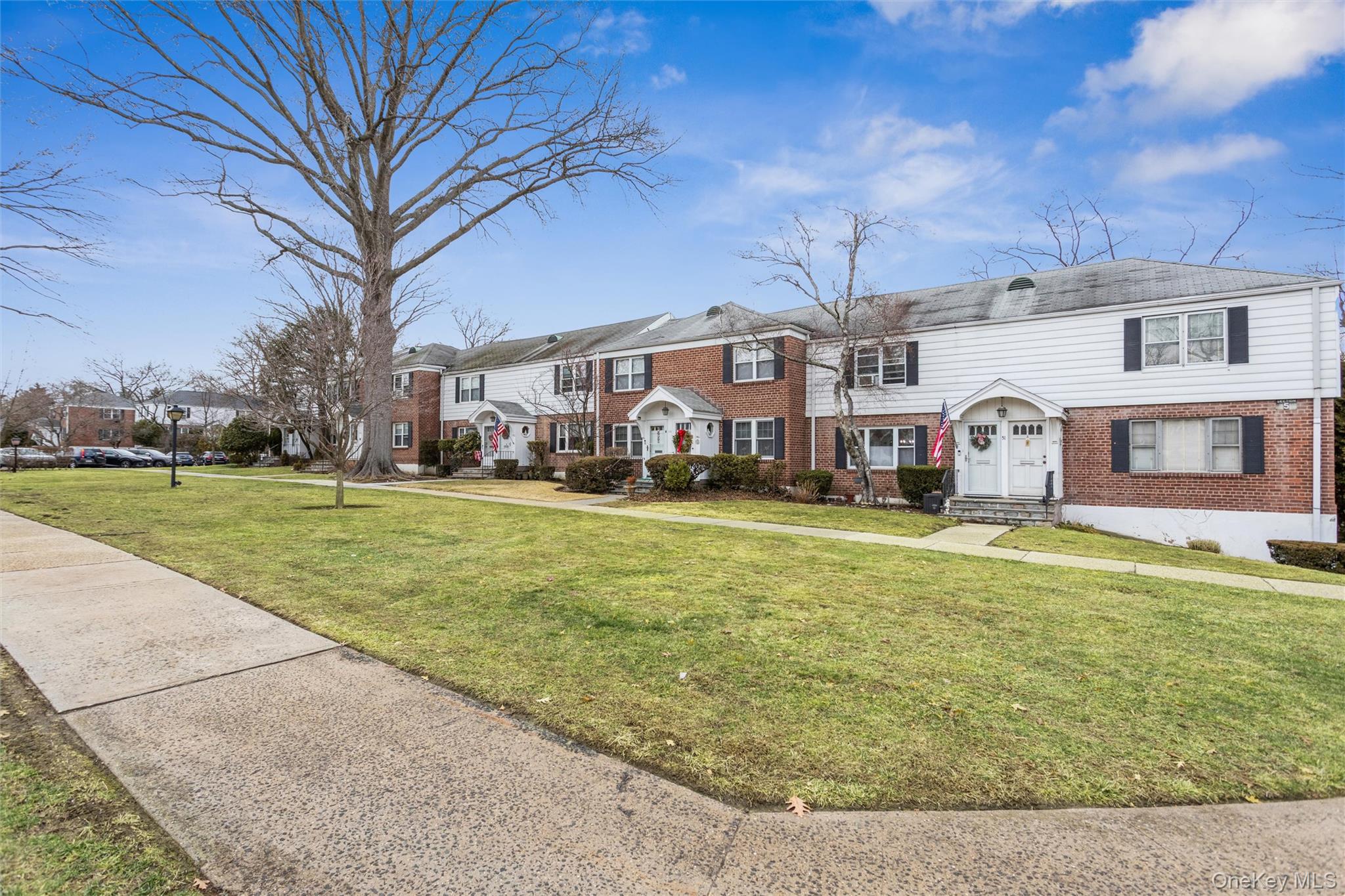 5 Peck Avenue, Unit 51B Rye, NY 10580 - Photo 26 of 31 a front view of a house with a yard