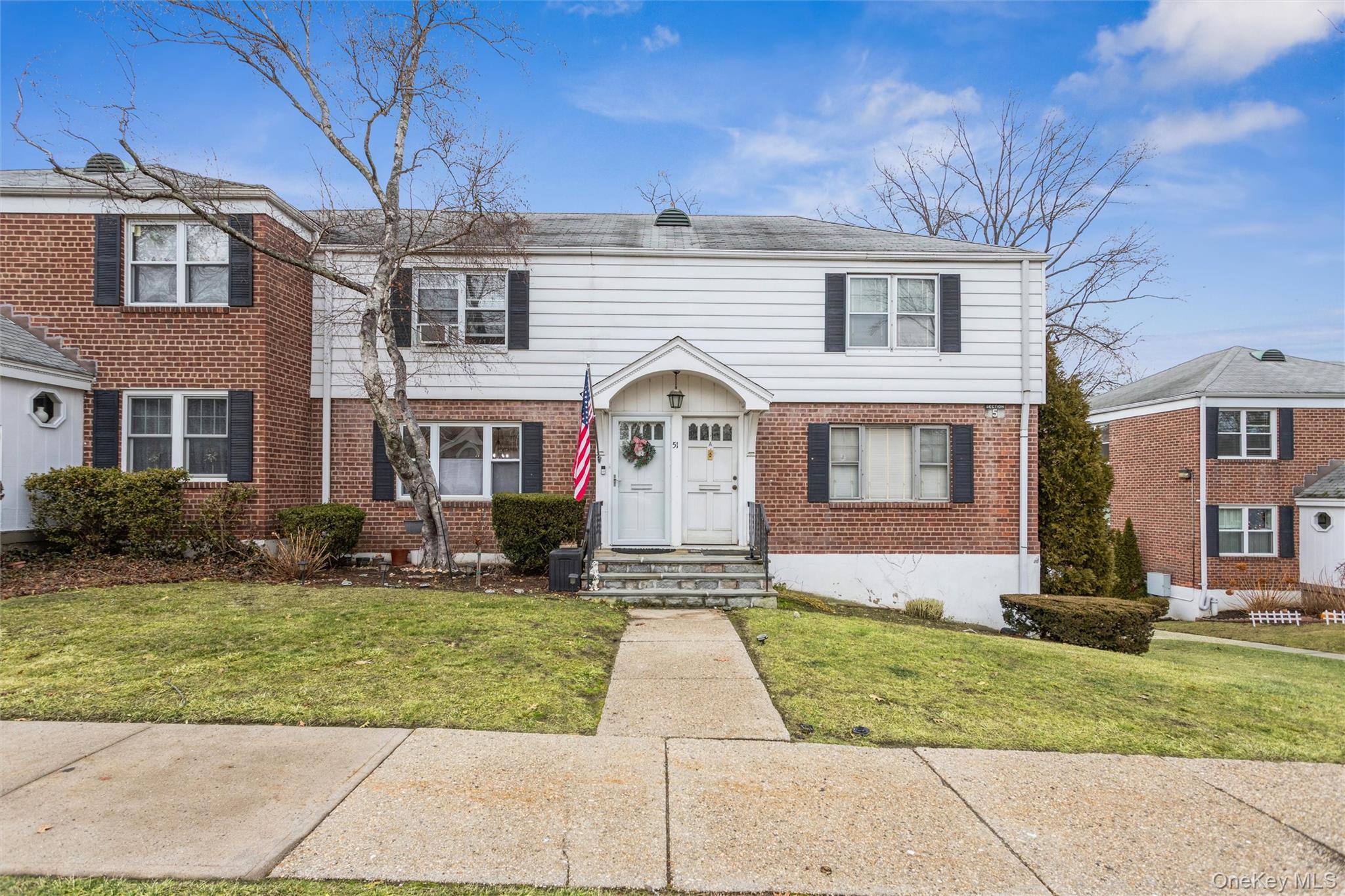5 Peck Avenue, Unit 51B Rye, NY 10580 - Photo 3 of 31 a front view of a house with a yard