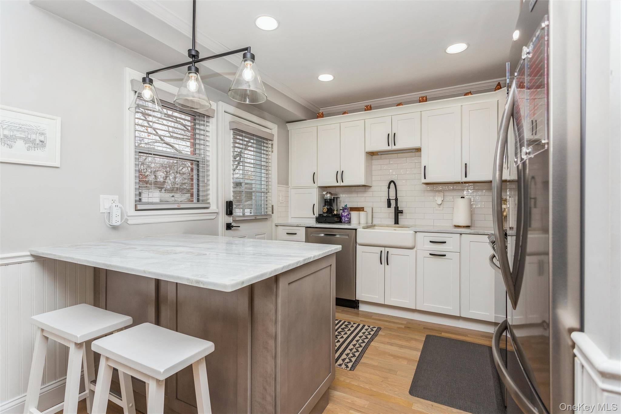 5 Peck Avenue, Unit 51B Rye, NY 10580 - Photo 10 of 31 a kitchen with a center island appliances and cabinets