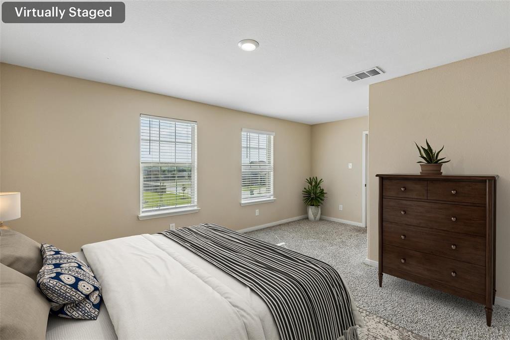 230 Enchanted Way Princeton, TX 75407 - Photo 12 of 31 a bedroom with a bed and a dresser