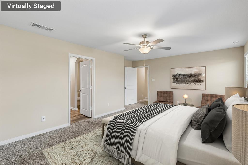 230 Enchanted Way Princeton, TX 75407 - Photo 16 of 31 a spacious bedroom with a bed and a chandelier
