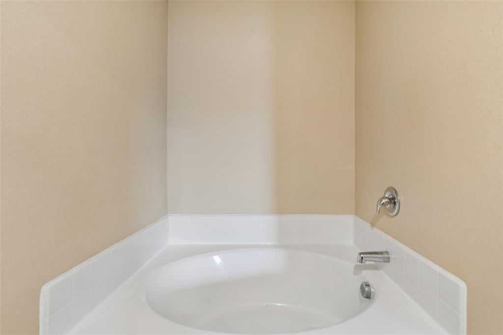 230 Enchanted Way Princeton, TX 75407 - Photo 20 of 31 a white bath tub sitting in a bathroom