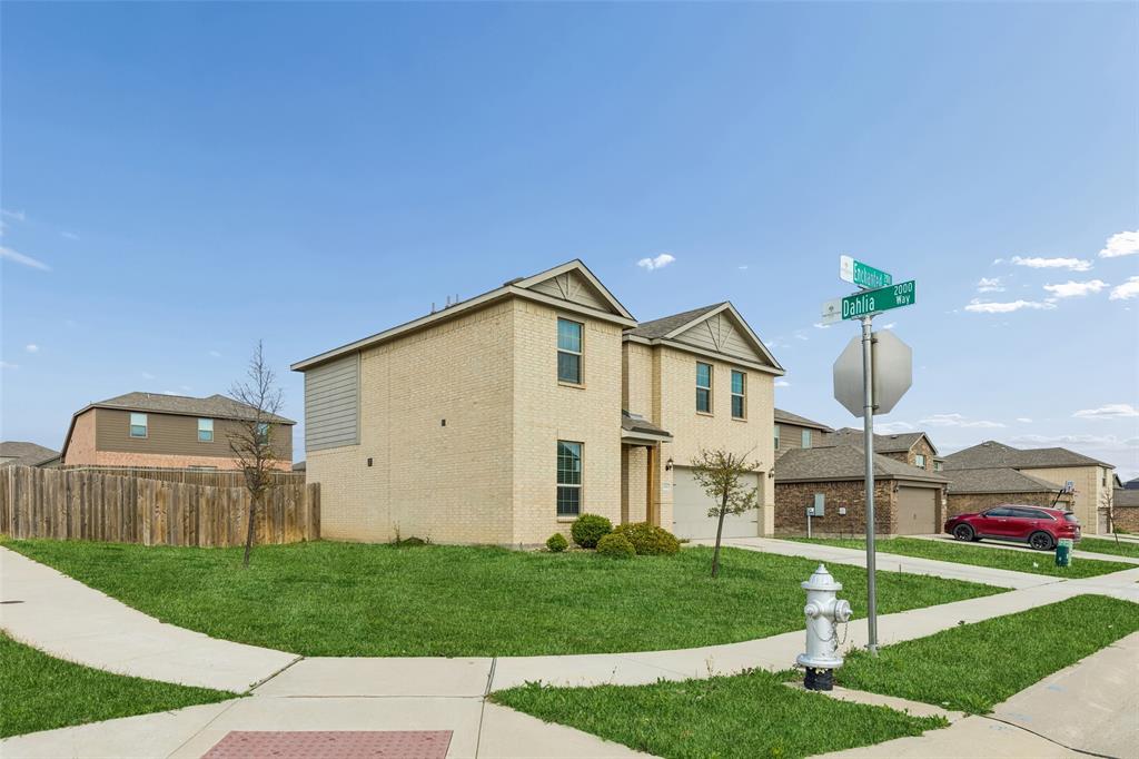 230 Enchanted Way Princeton, TX 75407 - Photo 2 of 31 a front view of a house with a garden and yard
