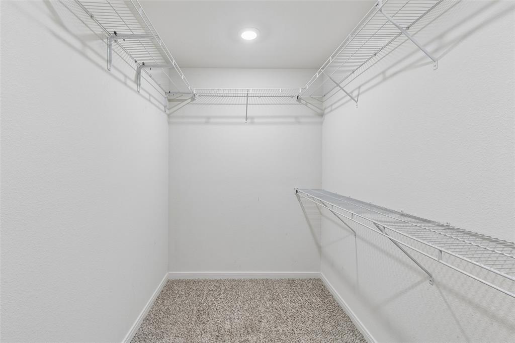 230 Enchanted Way Princeton, TX 75407 - Photo 21 of 31 a view of a room with racks on the wall