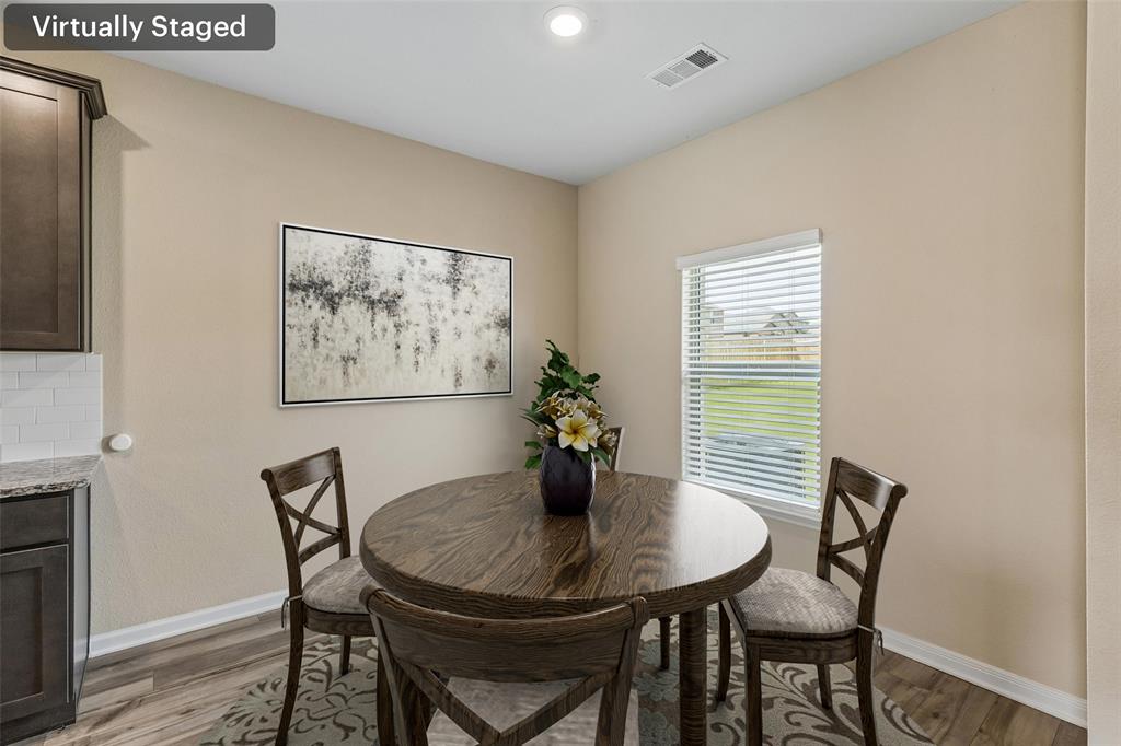 230 Enchanted Way Princeton, TX 75407 - Photo 7 of 31 a view of a dining room with furniture and wooden floor