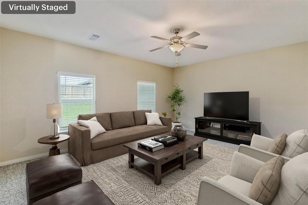 230 Enchanted Way Princeton, TX 75407 - Photo 9 of 31 a living room with furniture and a flat screen tv