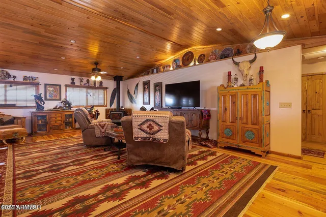 a living room with lots of furniture and wooden floors
