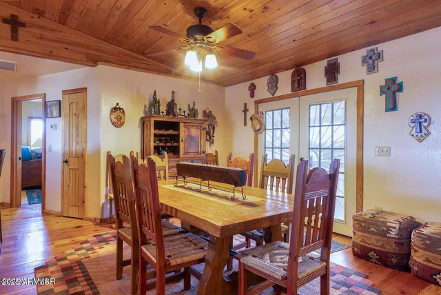 a spacious bedroom with a bed a couch and a chandelier