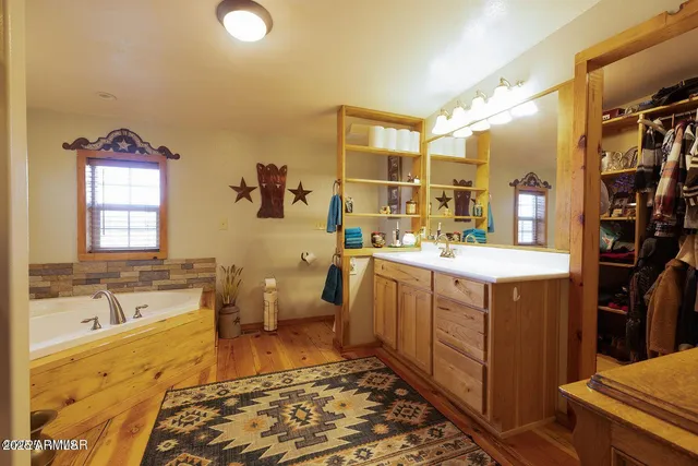 a bedroom with a bed dresser and a large window