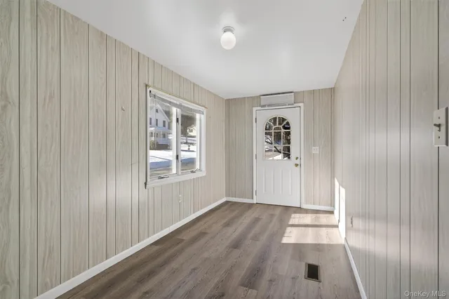 wooden floor in an empty room with a window