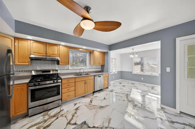 a kitchen with stainless steel appliances granite countertop a stove and a refrigerator