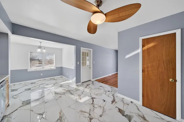 a bedroom with natural light and wooden floor