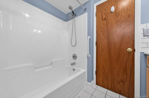 a bathroom with a bathtub and shower