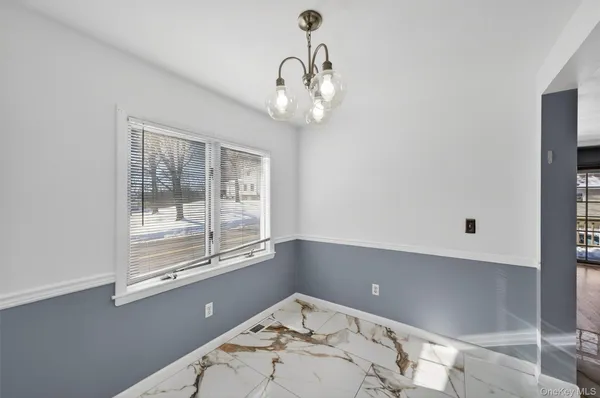 a view of a chandelier fan and wooden floor in a room
