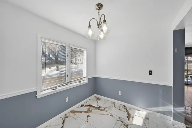 a view of a chandelier fan and wooden floor in a room