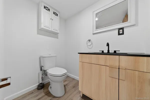 a bathroom with a toilet and a mirror