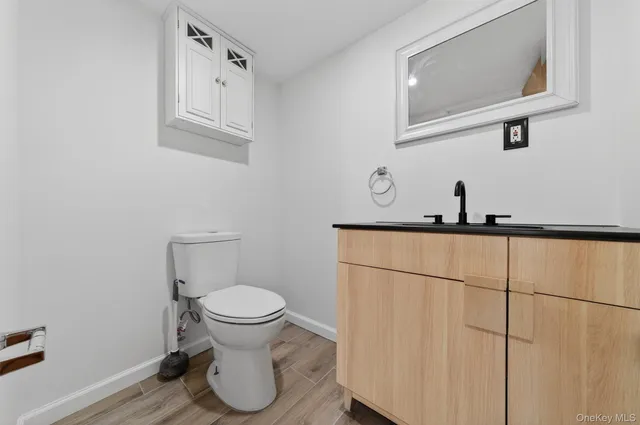 a bathroom with a toilet and a mirror