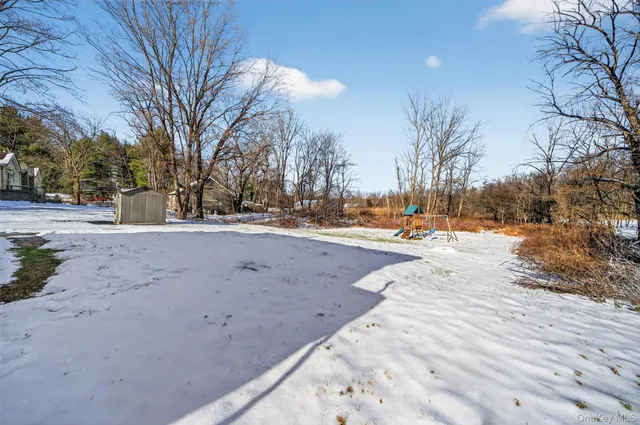 a patio with a table and chairs under an umbrella