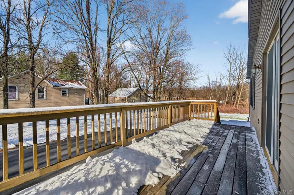 a view of balcony with wooden floor and fence