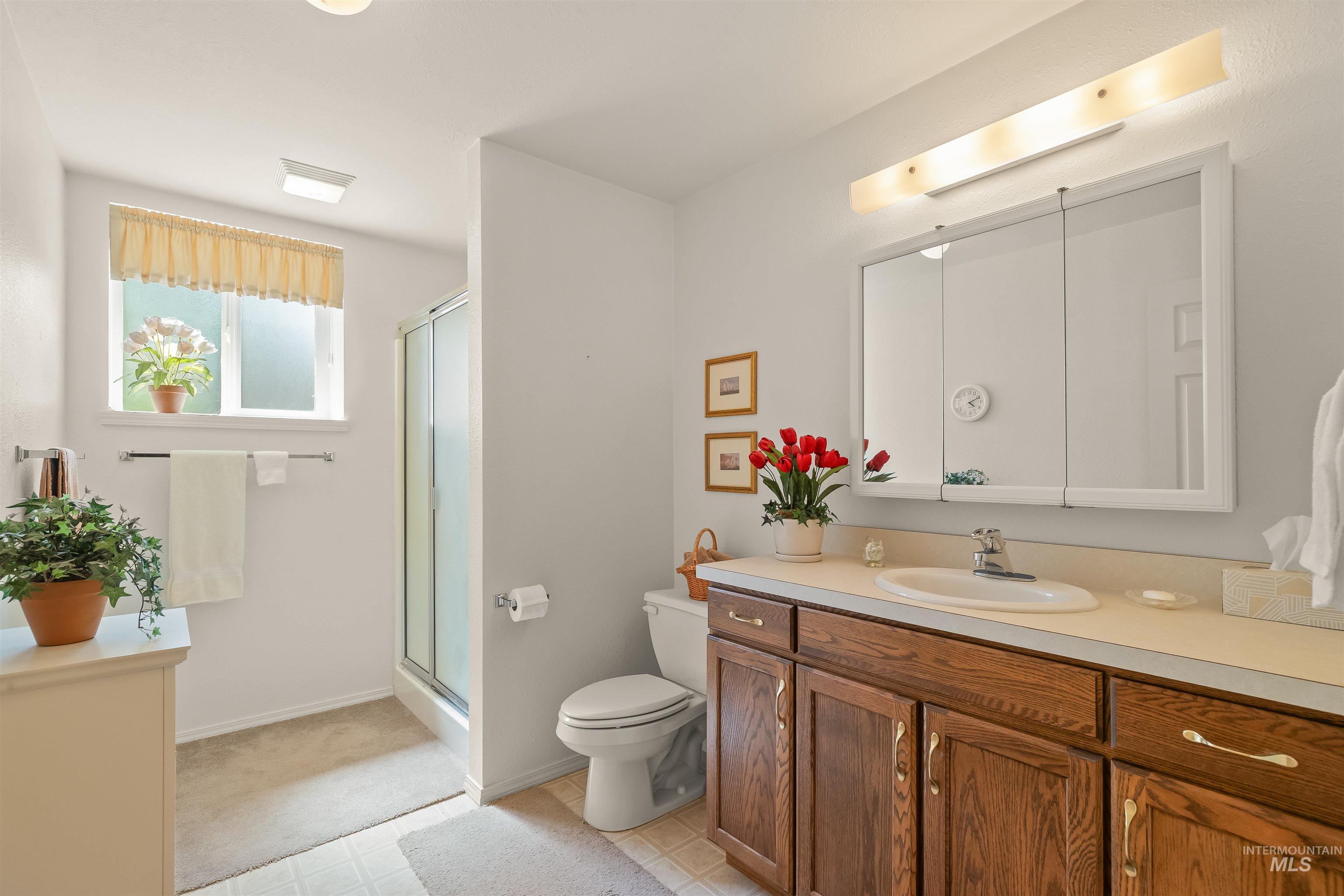 743 Wall Crk Road Stites, ID 83552 - Photo 35 of 48 Bathroom with a wood-finish vanity, light-toned countertop, and an integrated sink