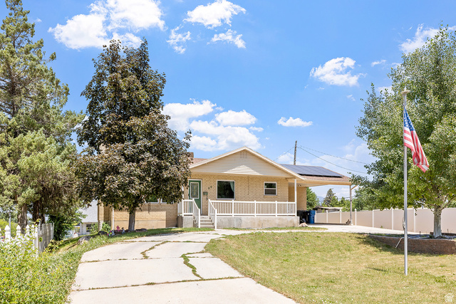 88 West 700 South Payson, UT 84651 - Photo 27 of 27 View of front of property with a porch, brick siding, and roof mounted solar panels