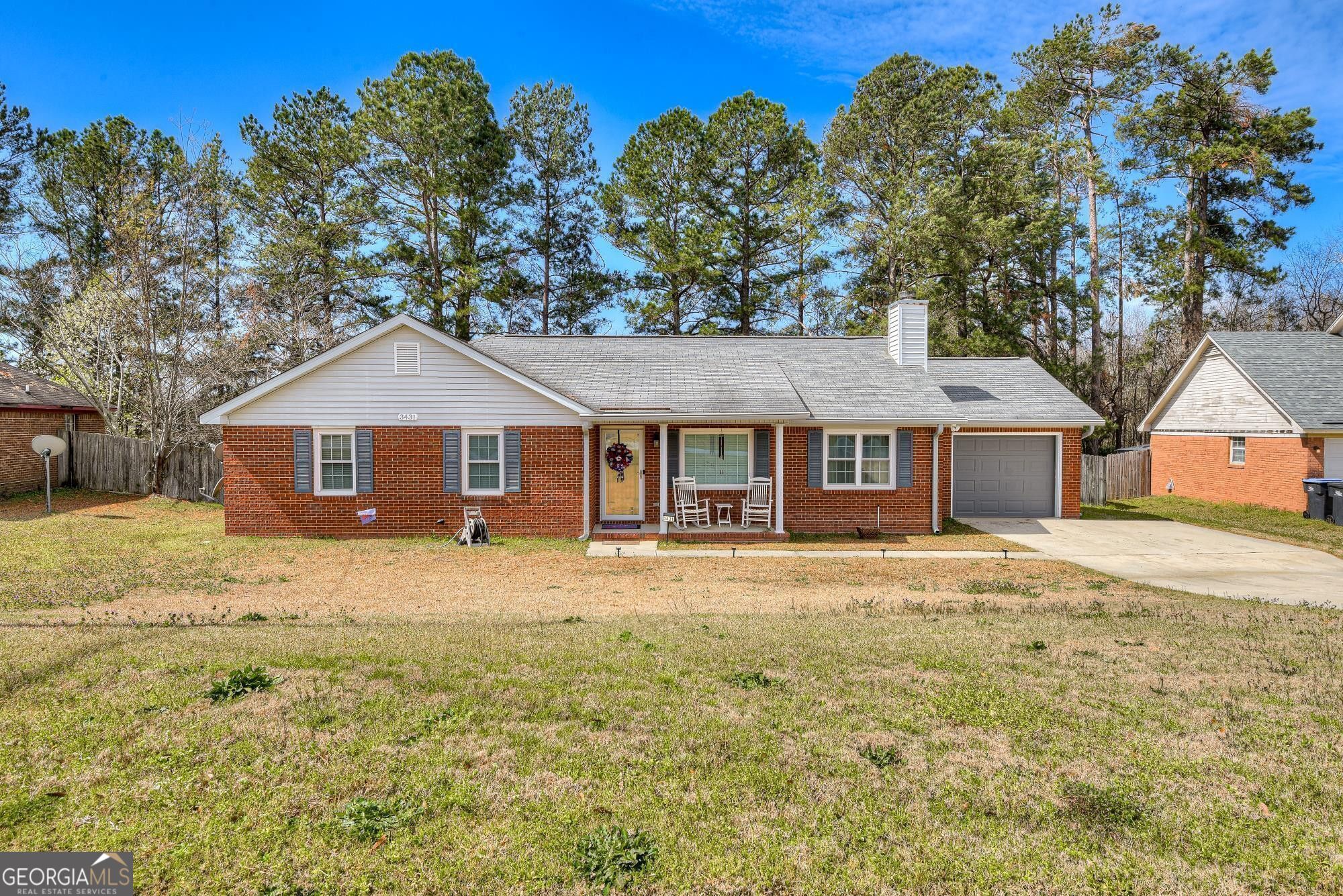 3431 Toms Drive Augusta, GA 30906 - Photo 1 of 1 a front of a house with a yard covered with trees
