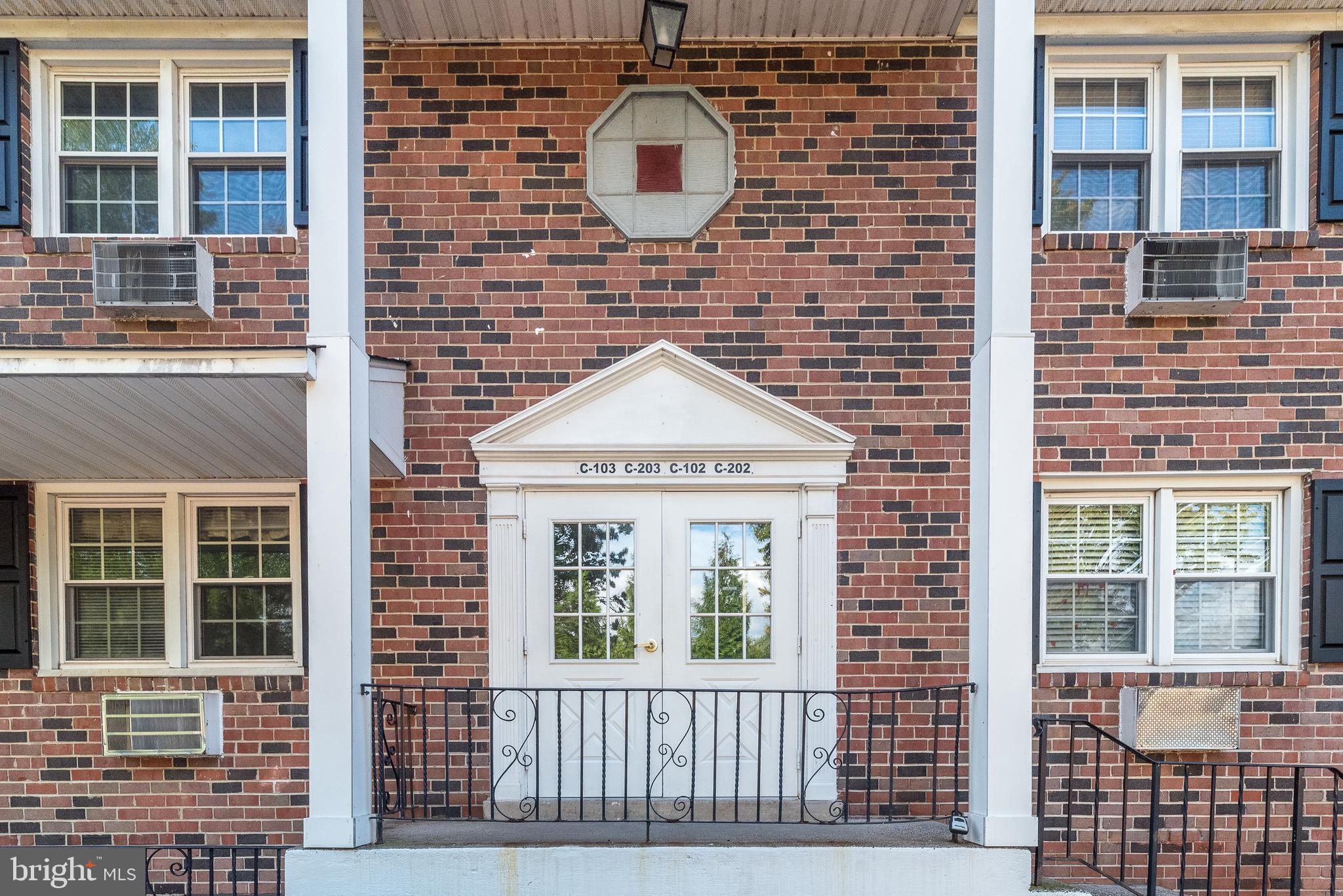 a front view of a brick house many windows