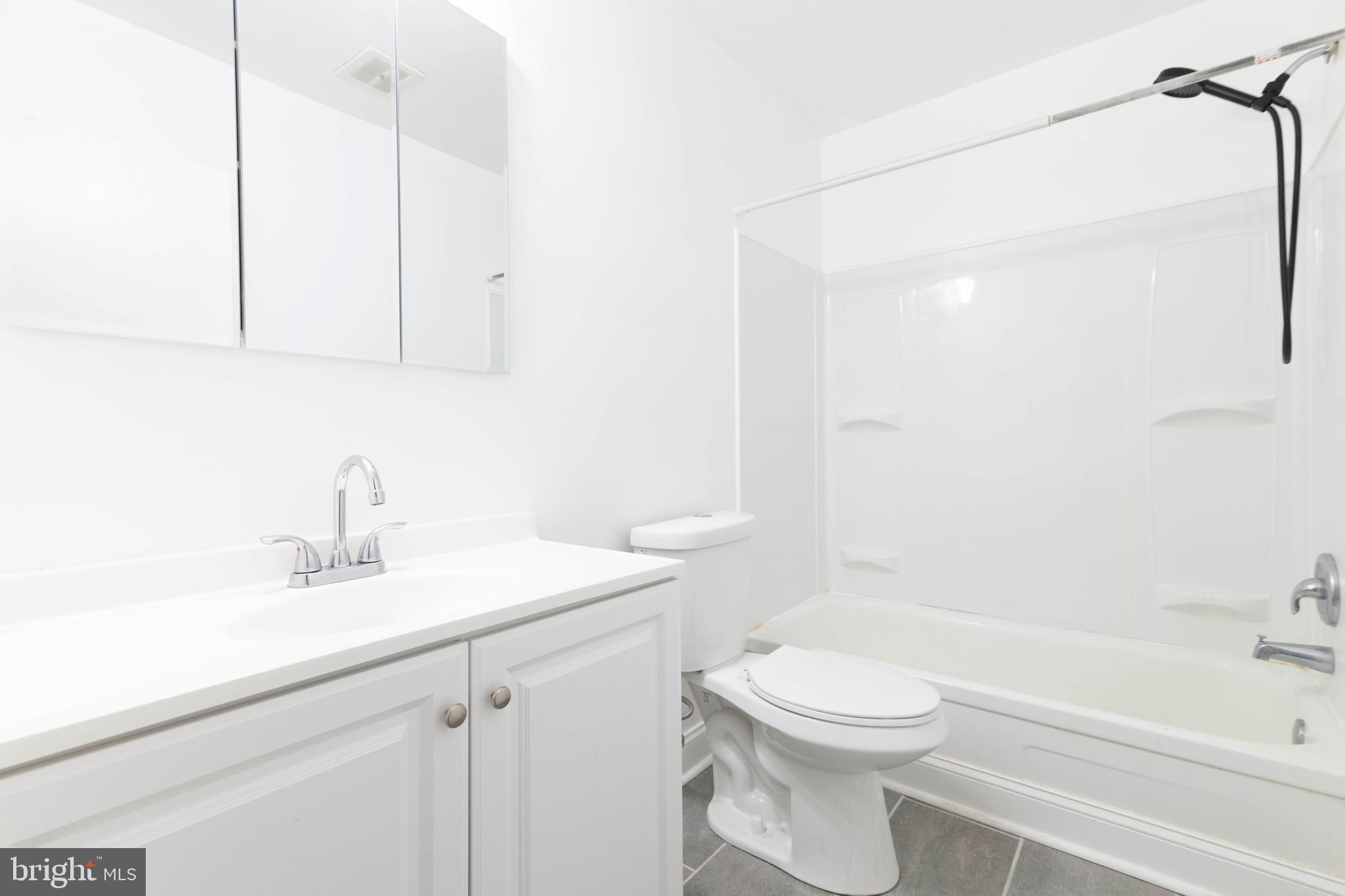 403 South Main Street, Unit C202 Doylestown, PA 18901 - Photo 11 of 18 a bathroom with a sink a toilet and shower