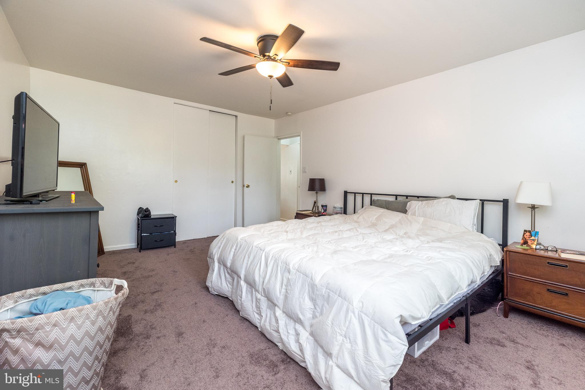 403 South Main Street, Unit C202 Doylestown, PA 18901 - Photo 13 of 18 a bedroom with bed and a chandelier