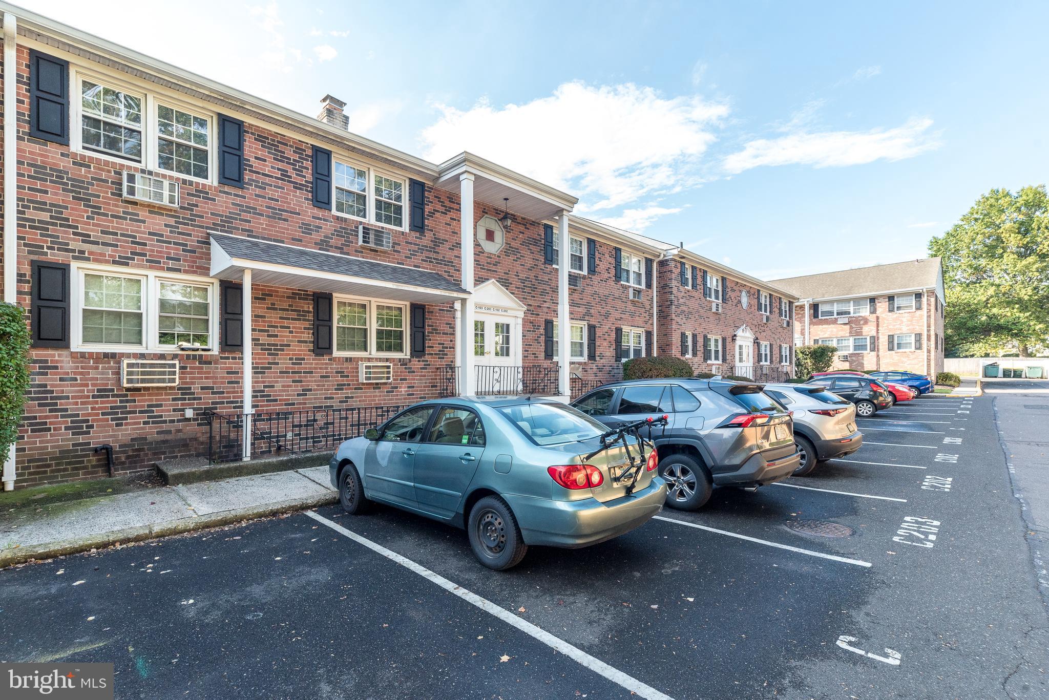 403 South Main Street, Unit C202 Doylestown, PA 18901 - Photo 2 of 18 a cars parked in front of a brick building