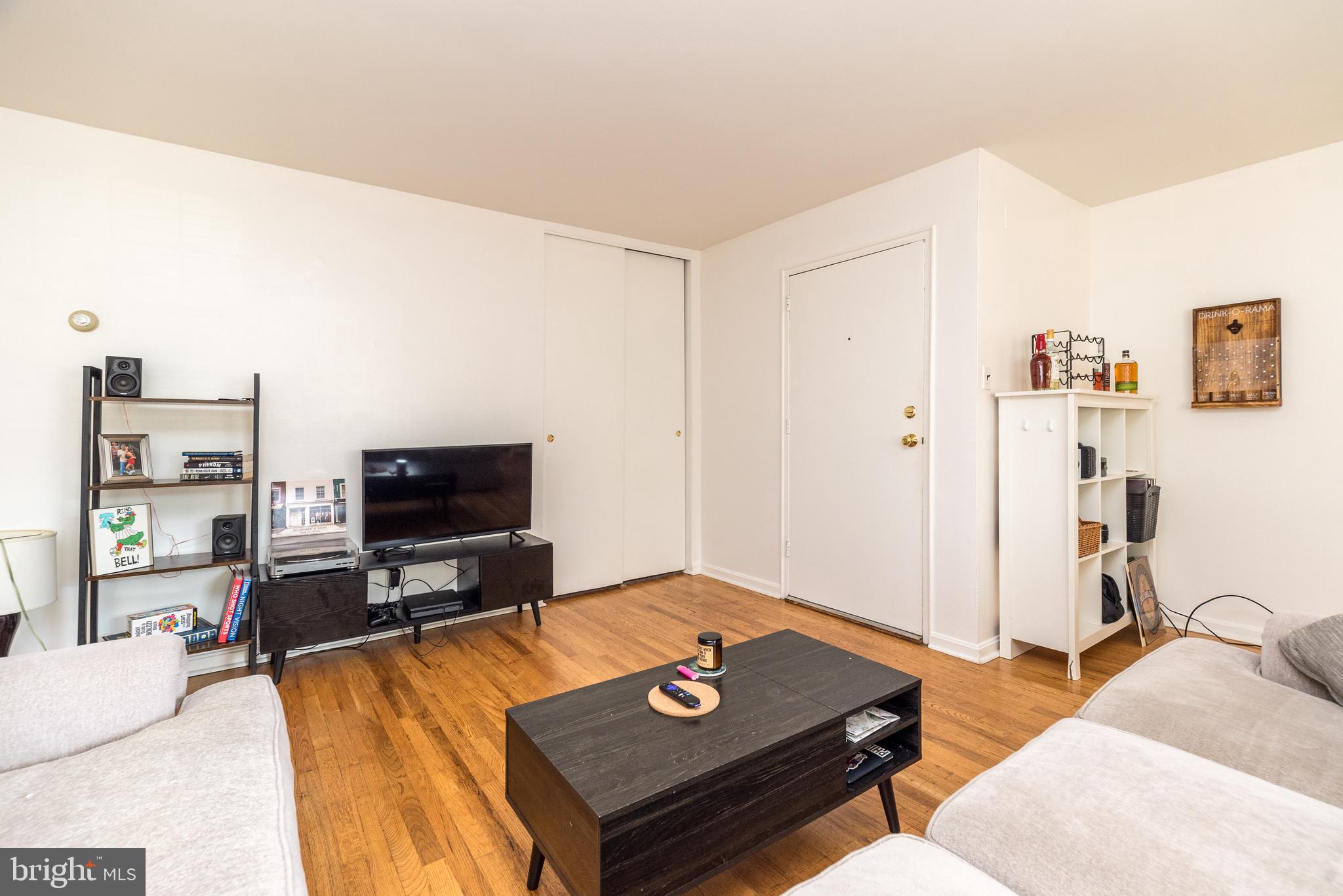 403 South Main Street, Unit C202 Doylestown, PA 18901 - Photo 8 of 18 a living room with furniture and a flat screen tv